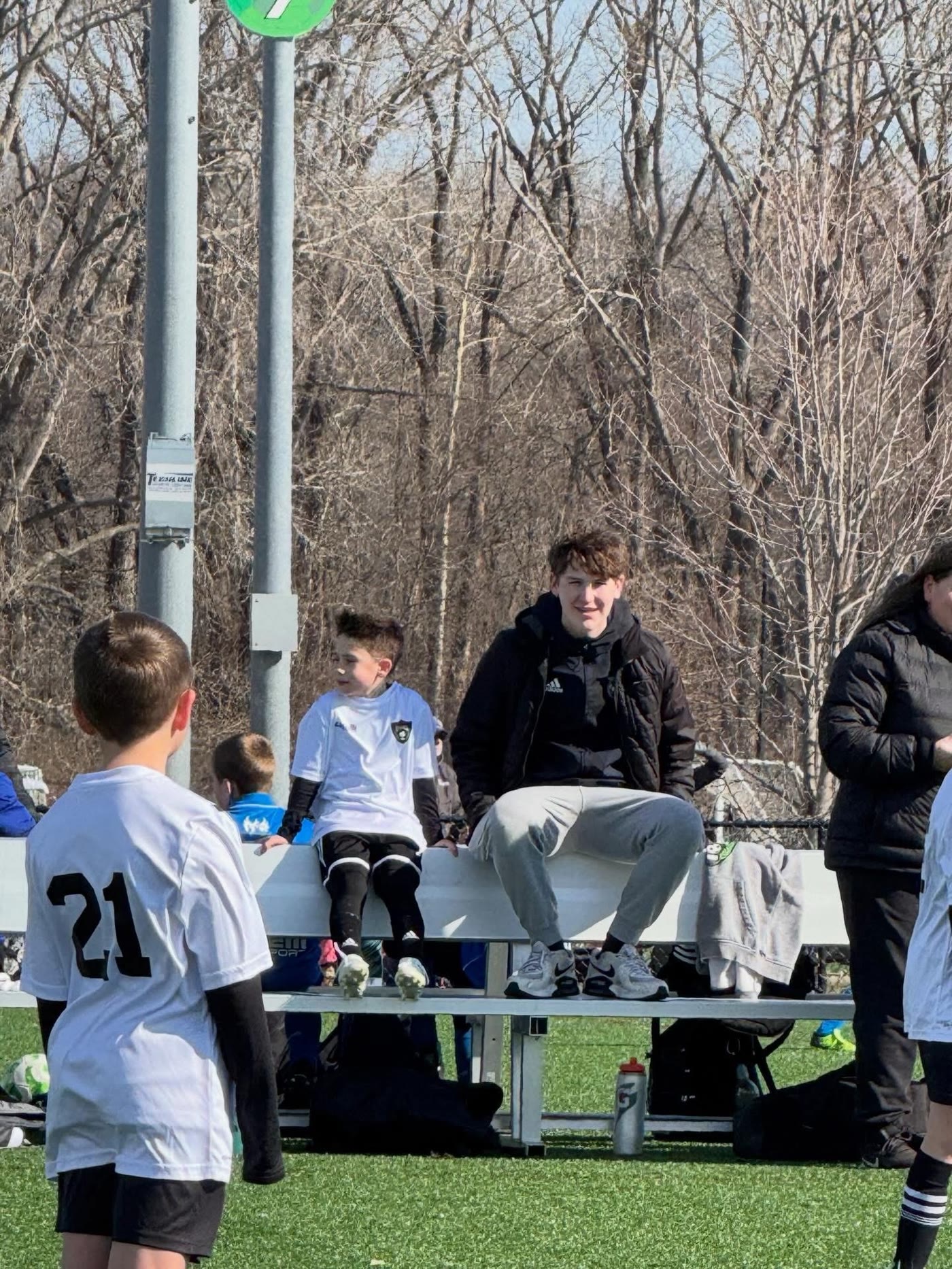 Legends players and coaches gathered near the bench during a match