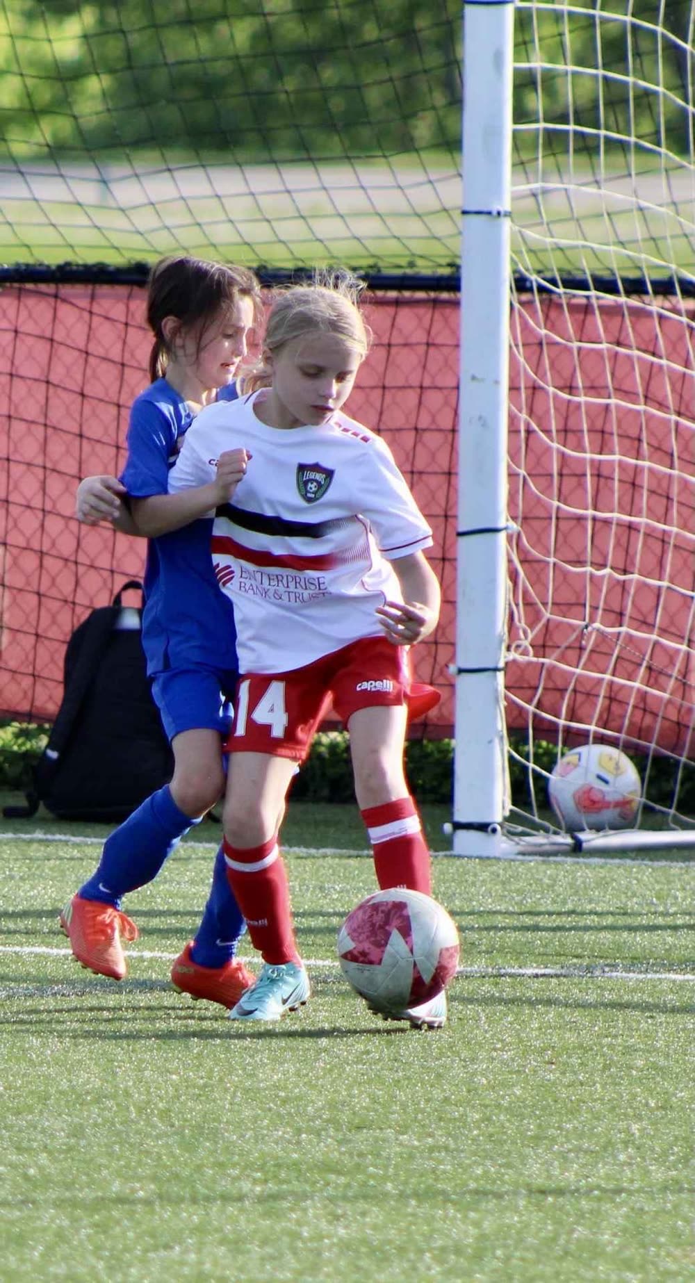 A St. Louis Legends player shields the ball near the goal during a one-on-one moment