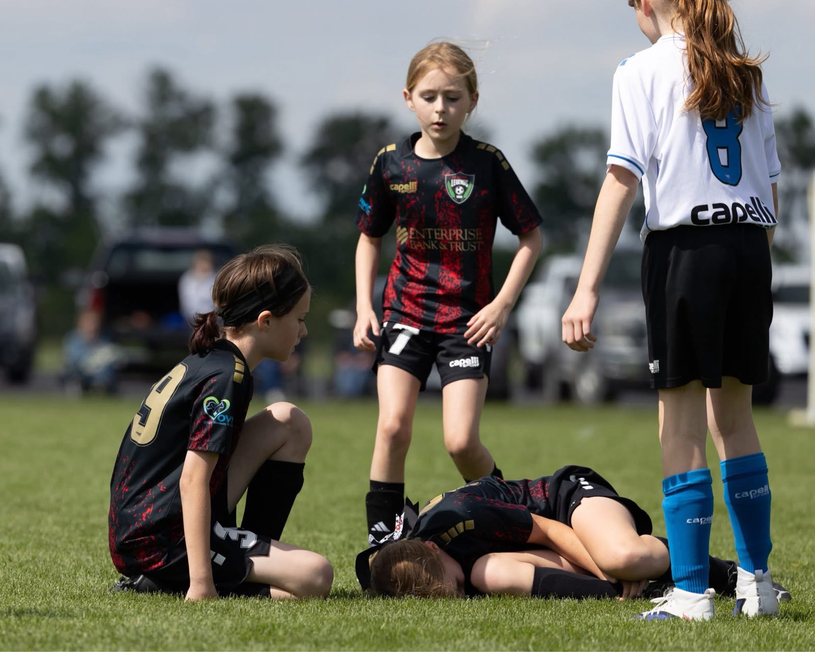St. Louis Legends players checking on a teammate during a match
